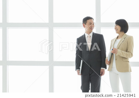 Business men and women walking while talking 21425941