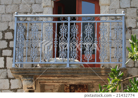 Dog sleeping on the balcony of the old 21432774