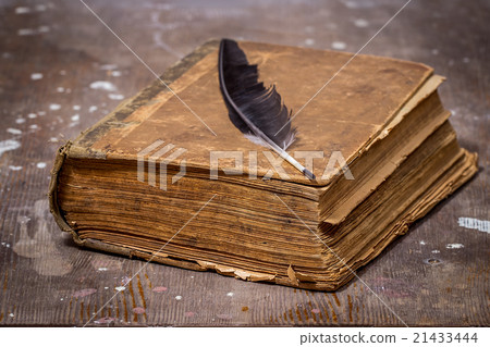 Ancient book in a grunge style on a wooden table 21433444