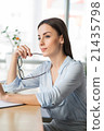 Pleasant  woman sitting at the table 21435798