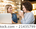 Cheerful  friends sitting at the table 21435799