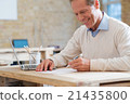 Cheerful man sitting at the table 21435800