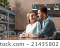 Young  loving couple sitting at the table 21435802