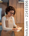 Cheerful girl making notes 21435806