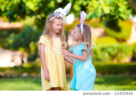 Two adorable little sisters wearing bunny ears on Two adorable little sisters wearing bunny ears on 21435938