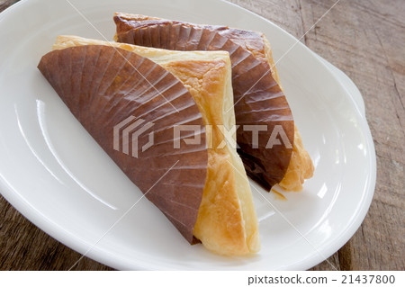 Pie triangular shape on white dish 21437800