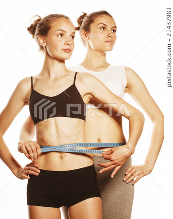 two sport girls measuring themselves isolated on two sport girls measuring themselves isolated on 21437981