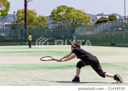 A woman playing tennis A woman playing tennis 21439550