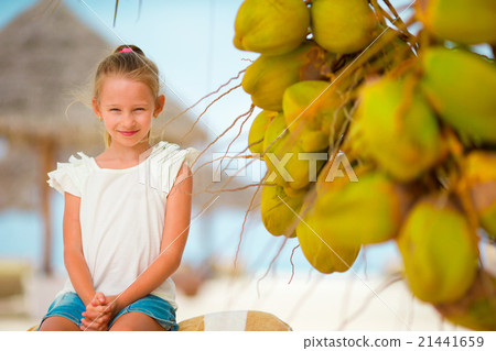 Little adorable girl with coconut on white Little adorable girl with coconut on white 21441659