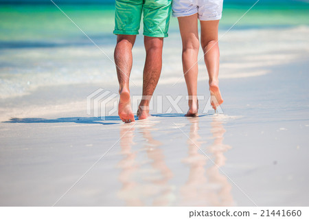 Low section of young couple on white beach at Low section of young couple on white beach at 21441660