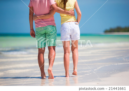 Young couple on white beach at summer vacation Young couple on white beach at summer vacation 21441661