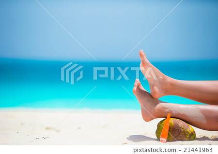 Female tanned smooth legs with suncream and 21441963