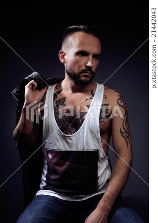 A man with tattooes on his arms. Silhouette of A man with tattooes on his arms. Silhouette of 21442043