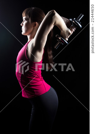 Fitness trainer doing exercise with weights 21444650