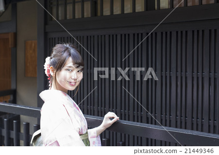 A young woman with a smile of kimono wandering around Gion town in Higashiyama Ward, Kyoto city A young woman with a smile of kimono wandering around Gion town in Higashiyama Ward, Kyoto city 21449346