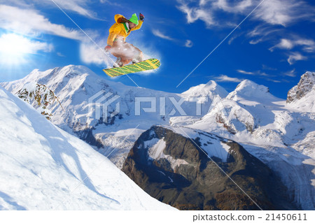 Snowboarder jumping in Swiss Alps 21450611