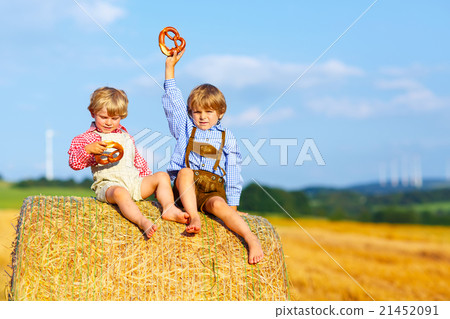Two little kid boys and friends sitting on hay Two little kid boys and friends sitting on hay 21452091