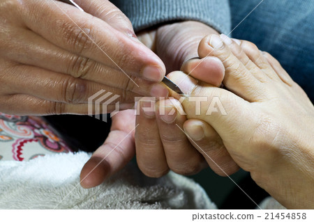 professional doing manicure pedicure 21454858