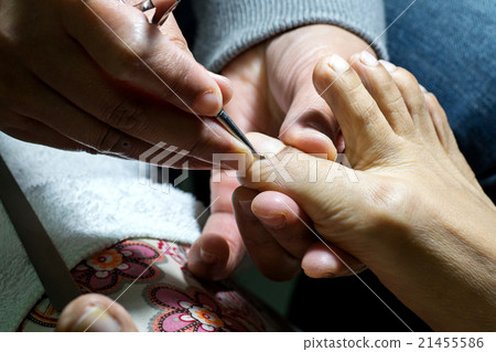 professional doing manicure pedicure 21455586