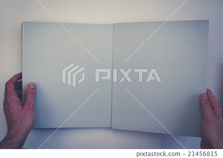 hands holding open book with blank pages 21456815