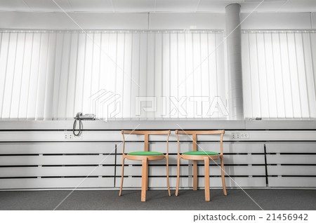 Green chairs in a bright office 21456942