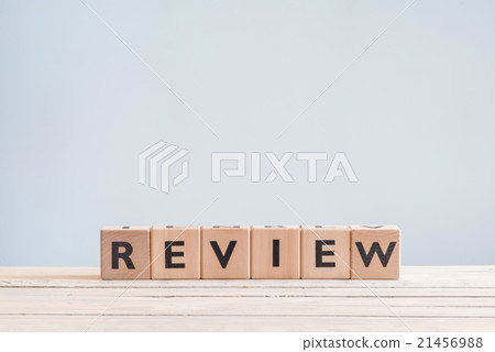 Review sign on a table 21456988