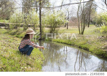 A girl playing in a stream 21458393
