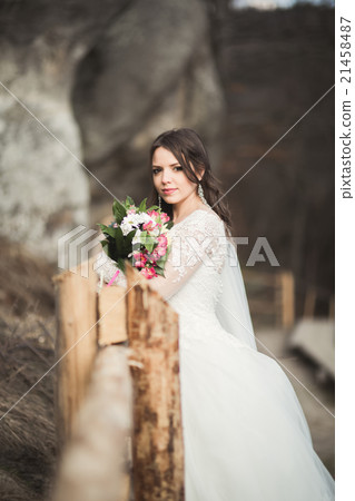 Beautiful bride posing near rocks with beautiful Beautiful bride posing near rocks with beautiful 21458487