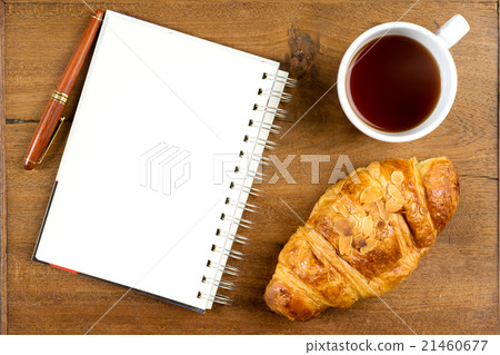 croissant cup coffee white book pen  on teak wood 21460677