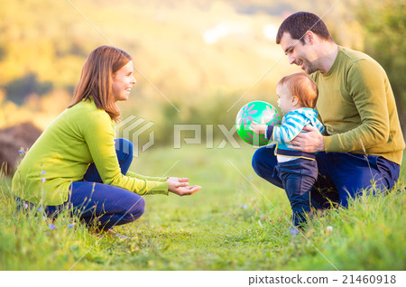 Parents holding their little son making first 21460918