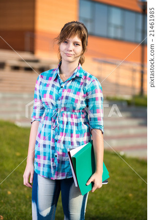 Portrait of young alluring woman holding education Portrait of young alluring woman holding education 21461985