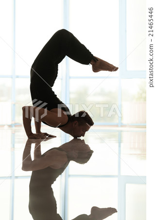Man works out at the yoga studio 21465446