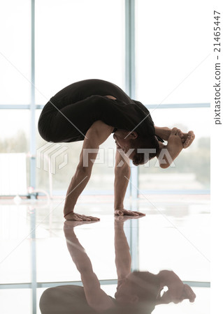 Man works out at the yoga studio 21465447