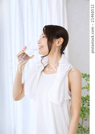 A woman drinking mineral water A woman drinking mineral water 21468512