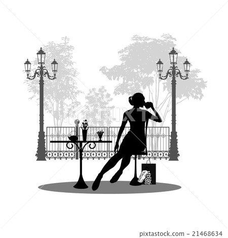 Silhouette of beautiful girl sitting in cafe. 21468634