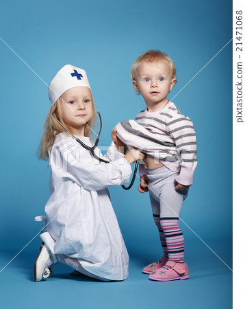 two cute little girls playing doctor two cute little girls playing doctor 21471068