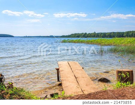 Beautiful clear lake with a wooden pier 21473855