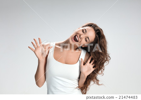 The young woman's portrait with funny emotions The young woman's portrait with funny emotions 21474483