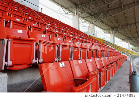 Red seats on the grandstand in the stadium Red seats on the grandstand in the stadium 21474892