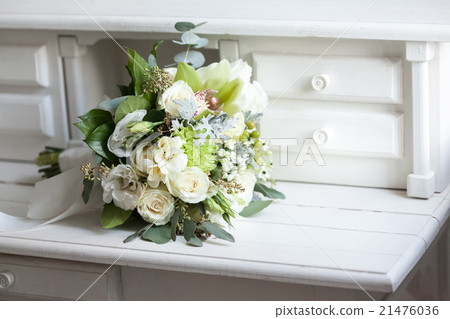 Wedding bouquet with white roses on wooden surface 21476036