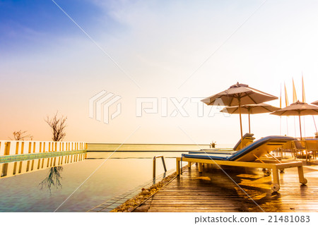 Umbrella and chair around swimming pool Umbrella and chair around swimming pool 21481083