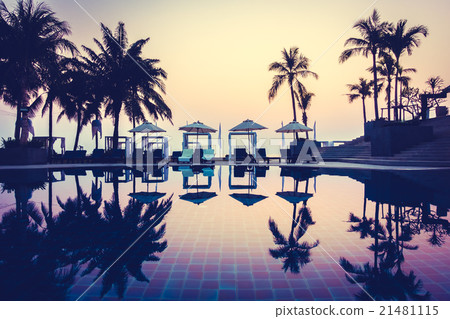 Beautiful Silhouette palm tree with umbrella and chair Beautiful Silhouette palm tree with umbrella and chair 21481115