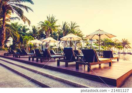 Beautiful Silhouette palm tree with umbrella and chair Beautiful Silhouette palm tree with umbrella and chair 21481127