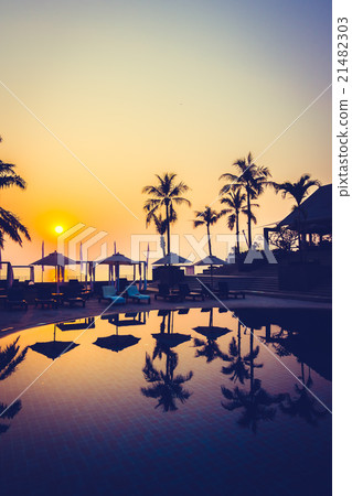 Beautiful Silhouette palm tree with umbrella and chair 21482303