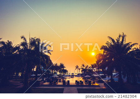 Beautiful Silhouette palm tree with umbrella and chair Beautiful Silhouette palm tree with umbrella and chair 21482304