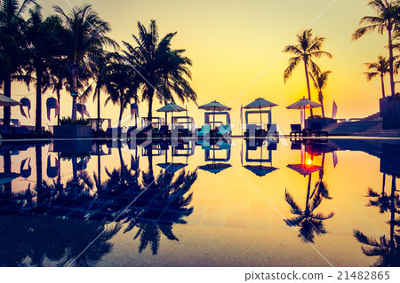 Beautiful Silhouette palm tree with umbrella and chair Beautiful Silhouette palm tree with umbrella and chair 21482865