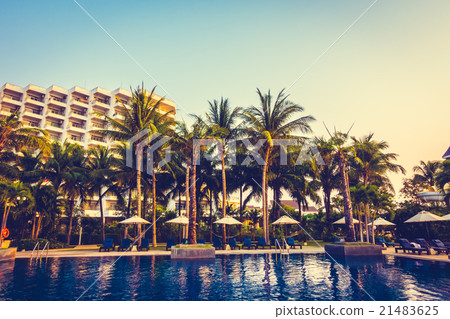 Beautiful Silhouette palm tree with umbrella and chair Beautiful Silhouette palm tree with umbrella and chair 21483625