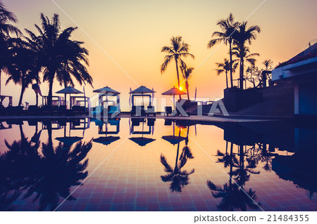 Beautiful Silhouette palm tree with umbrella and chair Beautiful Silhouette palm tree with umbrella and chair 21484355