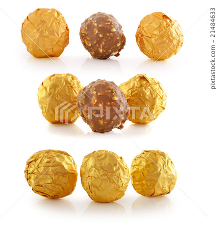 Sweet chocolate candy wrapped in golden foil Sweet chocolate candy wrapped in golden foil 21484633