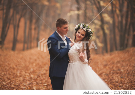 Happy wedding couple, bride and groom walking in Happy wedding couple, bride and groom walking in 21502832